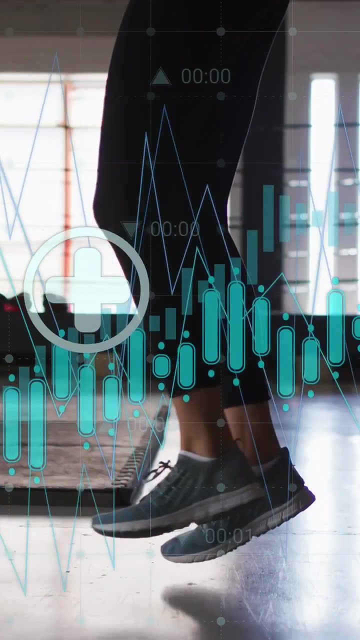Vertical video: Woman performing cardio footwork in gym, tapping phone activating HUD with graphs