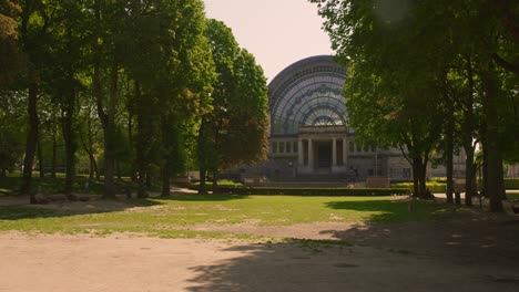 pan shot of arc de triomphe of brussels in the background with cinquantenaire park in the foreground in brussels, belgium on a sunny day