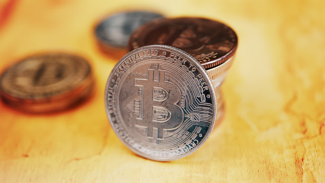 Close up of shiny physical Bitcoin coins stacked on a table