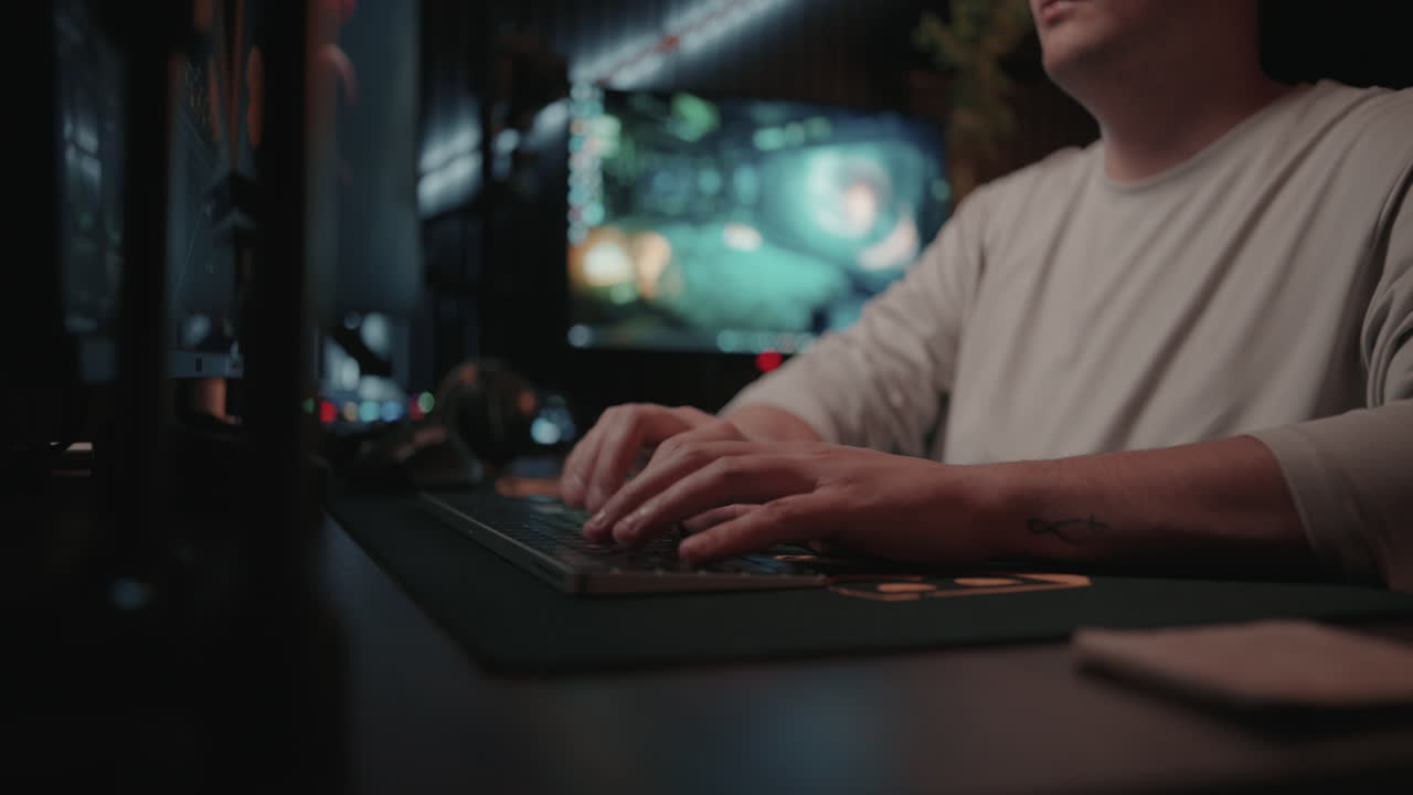 Man working on computer in a dark studio