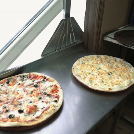 professional chef puts just now cooked pizza. italian pizza putting out from oven. ready for delivery sqare video