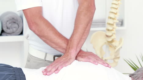 physiotherapist doing back massage to his patient