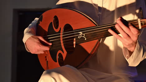 an arab musician plays the oud, a beloved traditional string instrument in arabic music