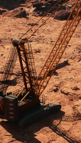 large orange crane in desert landscape