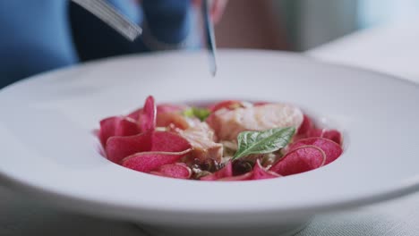 person eating a salmon dish in a very fancy and expensive restaurant, food close up