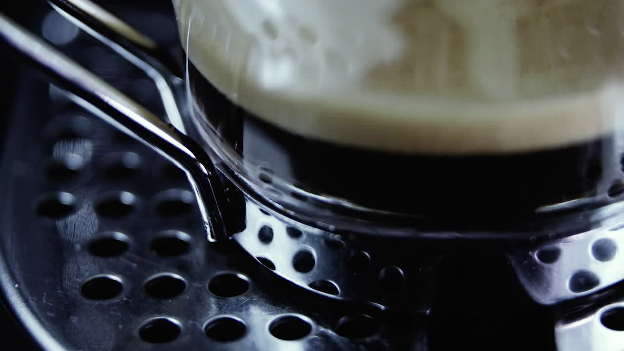 Close up of espresso cup on coffee machine. Static shot
