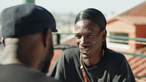 close-up shot of gay talking with partner on rooftop date