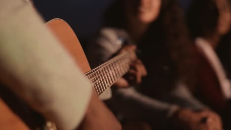 Close-up-of-man-playing-the-guitar-at-night/Dabrowa-Gornicza/Poland