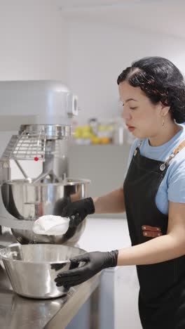 woman preparing food in a professional kitchen