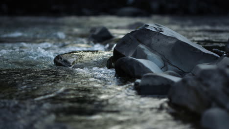 Mountain-river-flowing-in-slow-motion.-Water-stream-running-on-rocky-bottom.