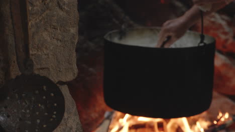 Traditional-Cheesemaking-Process-Over-Fire,-Stirs-in-Pot,-Chobareti-Georgia