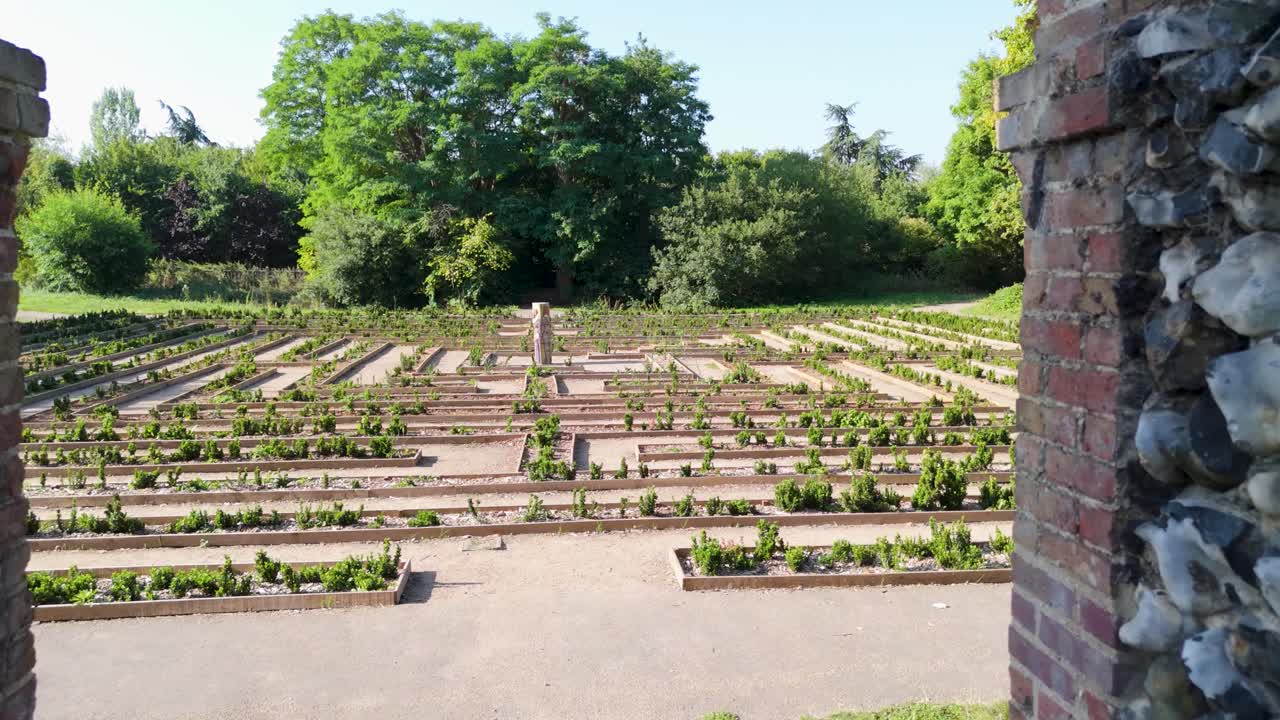 Drone flies through the historic flint archway at Cedar’s Park, Cheshunt, England, revealing the maze behind