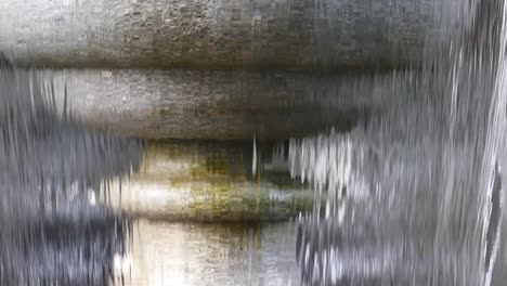 water cascading down a stone fountain