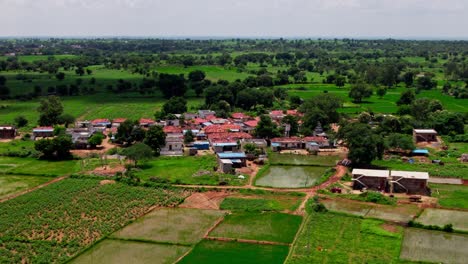 crop fields lands with tekmal village and cloud shadow moving on ground at tekmal, medak district, telangana, india. day time, push in, drone shot, 4k.