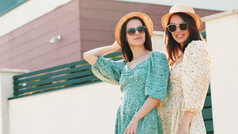 two women in floral dresses and hats