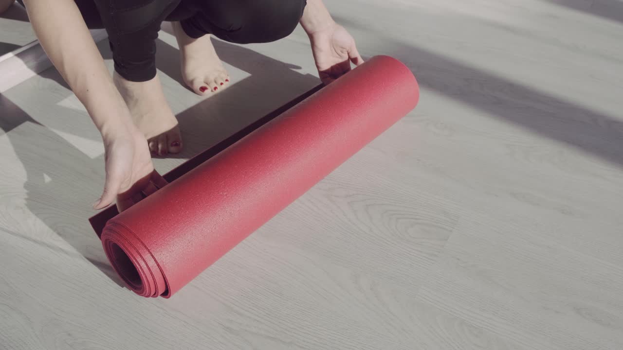 Red Yoga Mat on Wood Floor