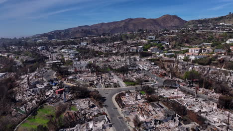 aerial view of neighborhood devastated by wildfire aftermath