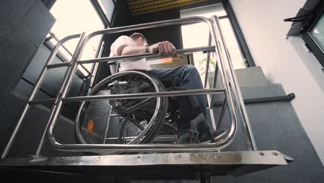 special elevator for the person with a physical disabilities. a man in a wheelchair uses a special elevator