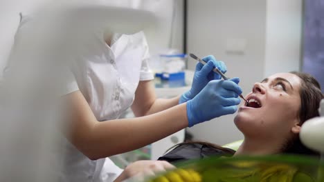 oral hygiene and dental care: doctor dentist working with patient in dental clinic. healthcare concept.