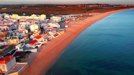 Panoramic-Aerial-Shot-of-Armação-de-Pêra-city-skyline-at-sunset