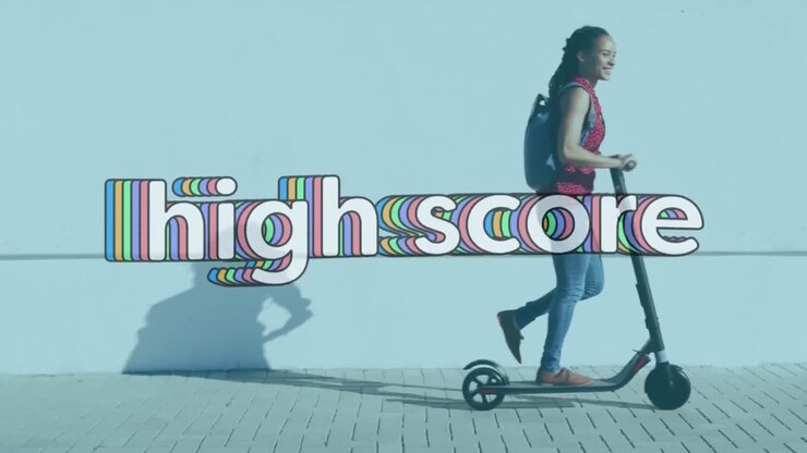 Animation of high score text over woman walking with electric scooter on pavement