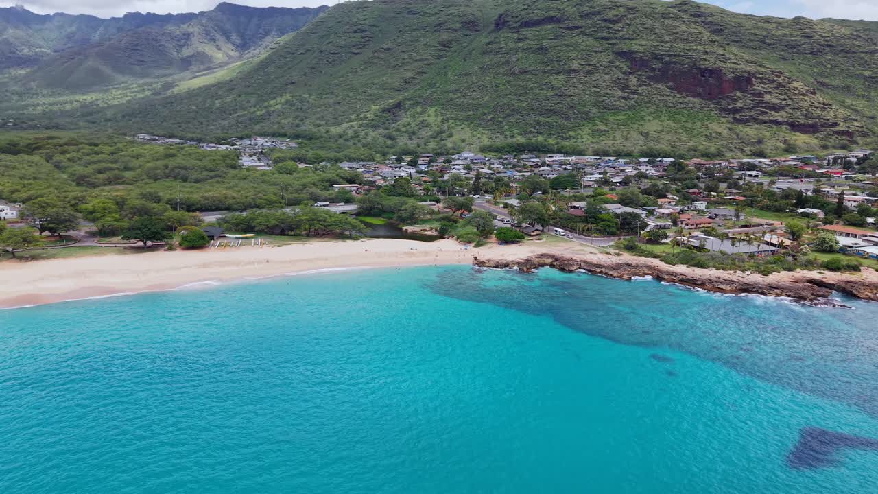 Nānākuli Beach with town at the base of the mountains in Oahu on Overcast Day, Aerial