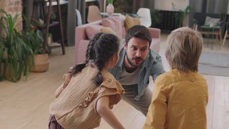 father dancing with his daughters