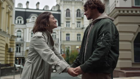 Happy-couple-holding-hands-in-old-town