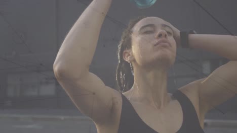 Animation-of-networks-of-connections-over-woman-pouring-water-over-head-exercising-in-city