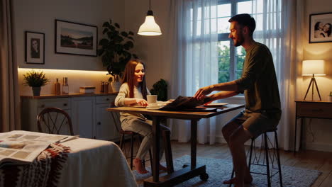 couple enjoying a meal and looking through old photos in a cozy kitchen at home