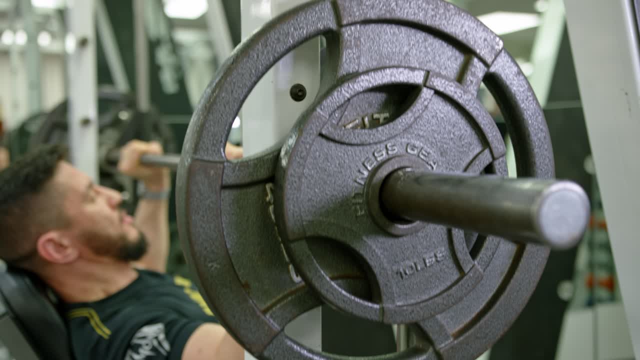 Active bodybuilder young man lifting heavy weights