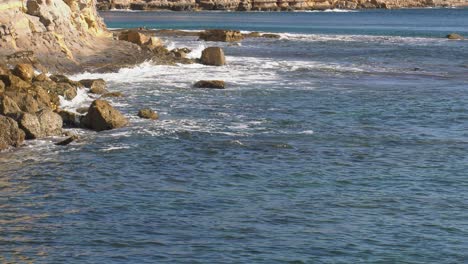 Ocean-waves-break-on-coastal-sea-cliffs,-mediterranean