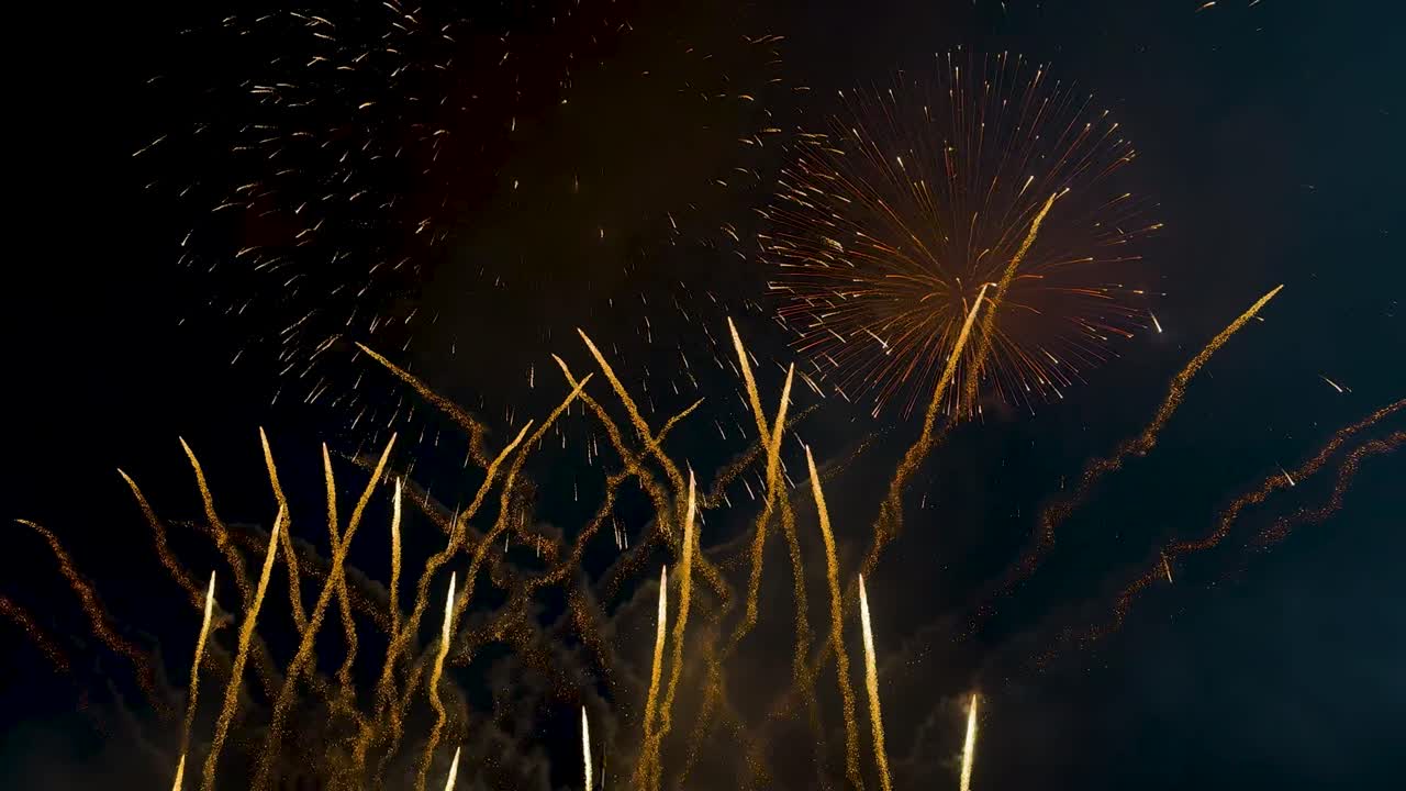 Gold fireworks on the night sky, large colorful celebration