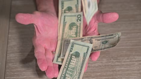 male senior citizen hands outstretched to catch money through financial opportunities in retirement