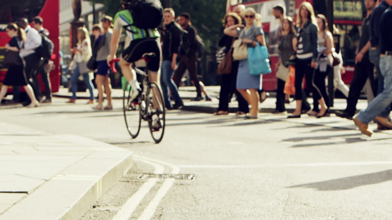 Anonymous crowd of business people walking in city streets london summer 2014