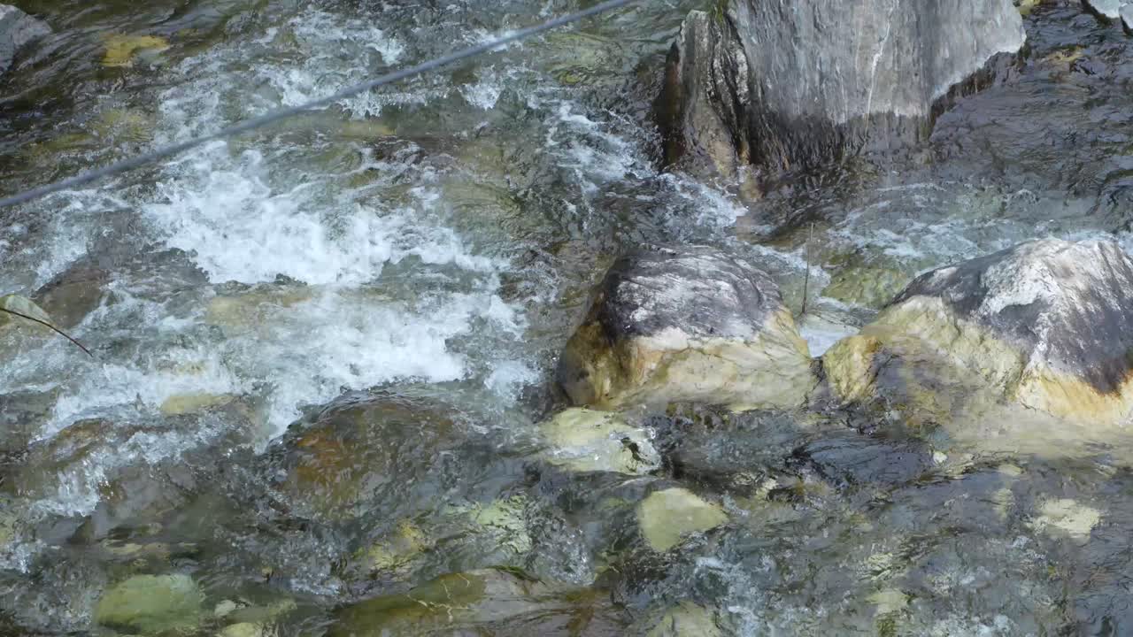 Water is flowing through a mountain torrential river.