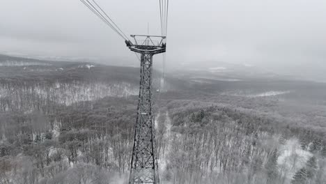 Riding-down-cable-car,-frontal-view-with-beautiful-snowy-landscape