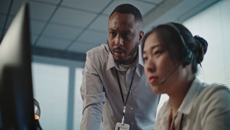 diverse colleagues collaborating at an office workstation