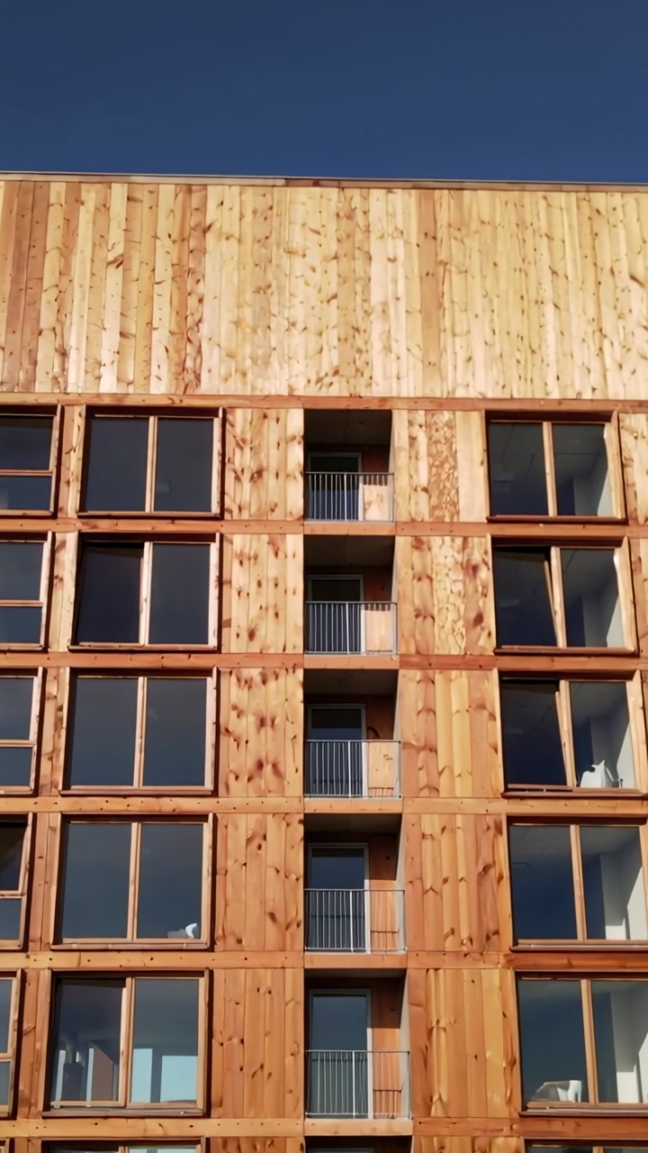 Vertical video: Tilting camera upward on start showing timber facade, windows, rails to show grain