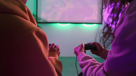 two friends gaming in a neon-lit room