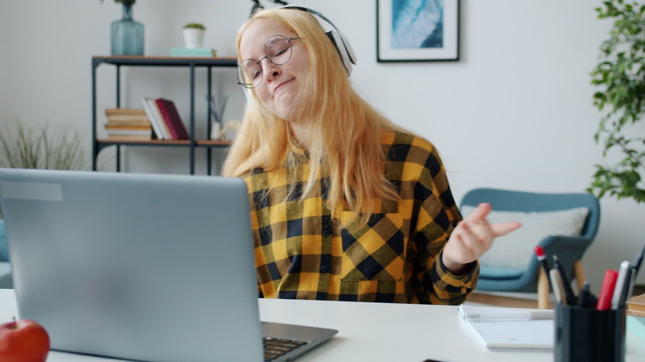 Teenager enjoys online class while listening to music