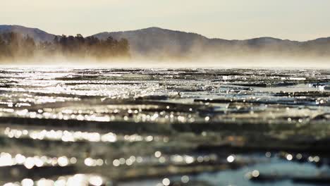 ice on the lake and drifting fog over the frozen surface