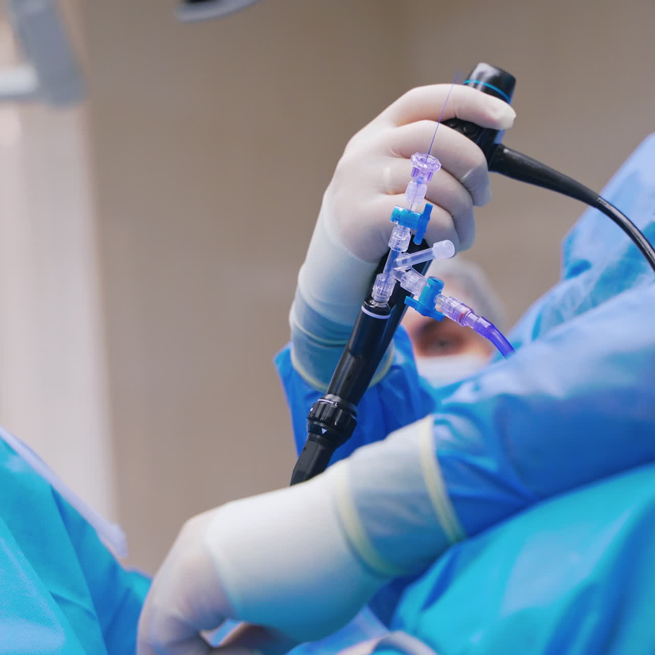 Specialist provides laparoscopic surgery. Surgical operation of the abdomen with new medical equipment. Close-up instrument in doctor's hands. New technologies in medicine.