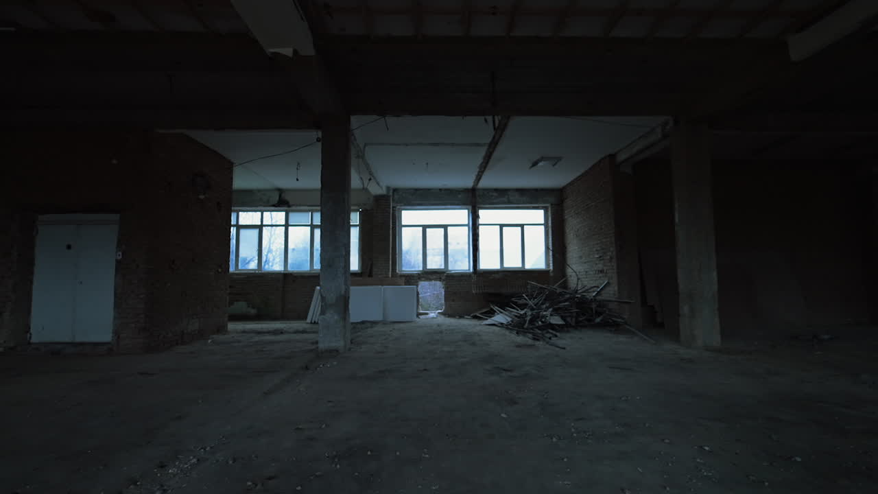 White square pieces of construction materials placed under the window of an unfinished premise. Some debris are left in a pile in the corner. Construction or reconstruction concept.