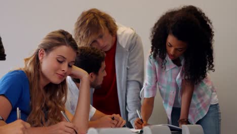 students working and taking notes together in class