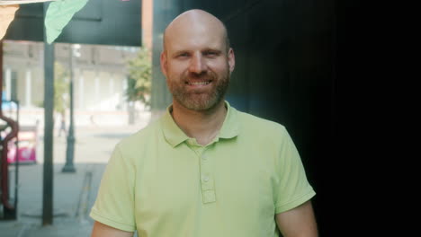 smiling man in a city alley