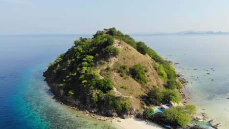 aerial jib or boom shot of pulau kelor island in komodo national park in indonesia, asia