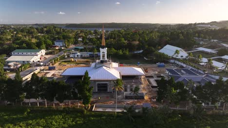 neiafu tonga temple under construction in vava'u island. drone reveal coastal scenery, pacific island.