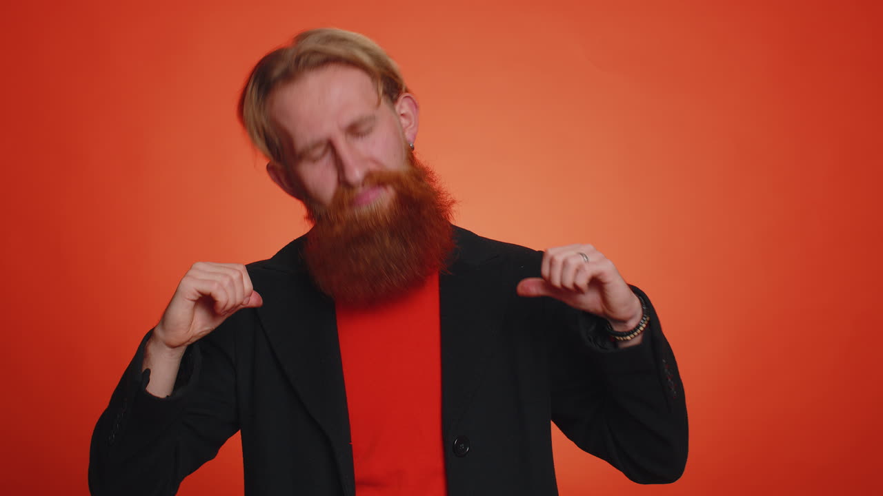 Happy bearded man feeling very proud pointing hisself, looking self-confident, overjoyed by success
