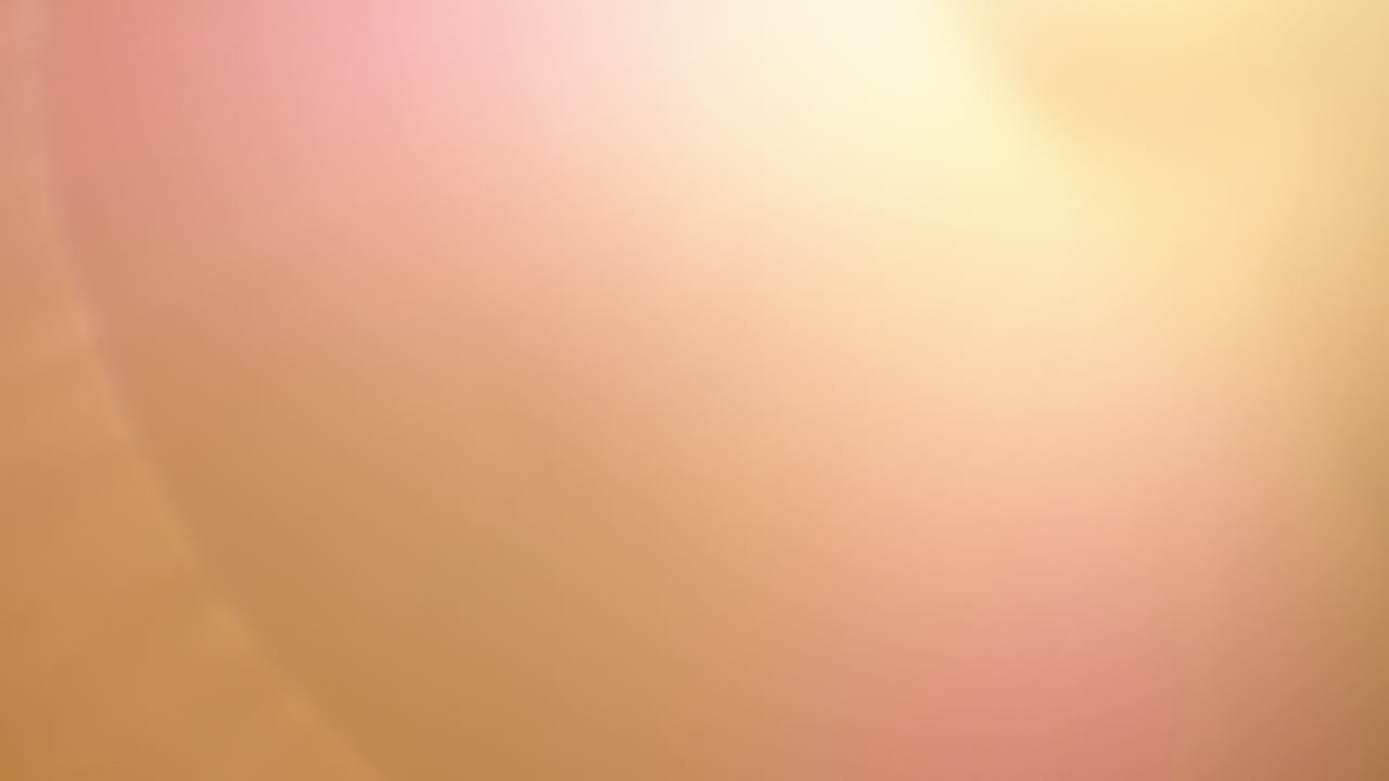 Transition of yellow light lens flare over black background